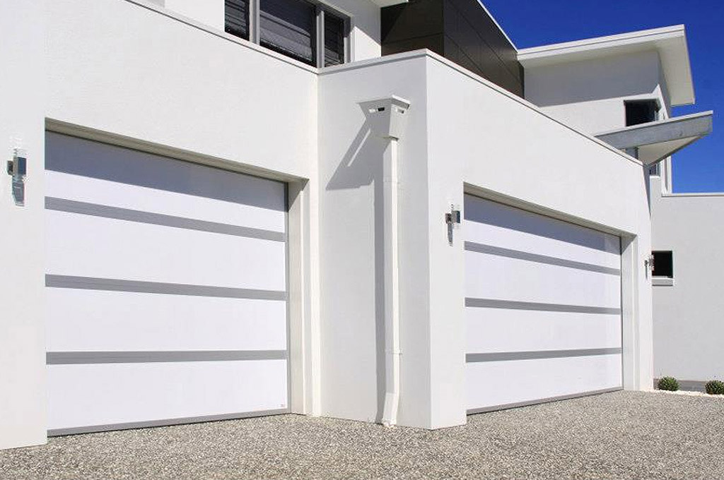 Modern white home with two-car garage featuring horizontal-striped doors. A Grade Garage Doors, Perth