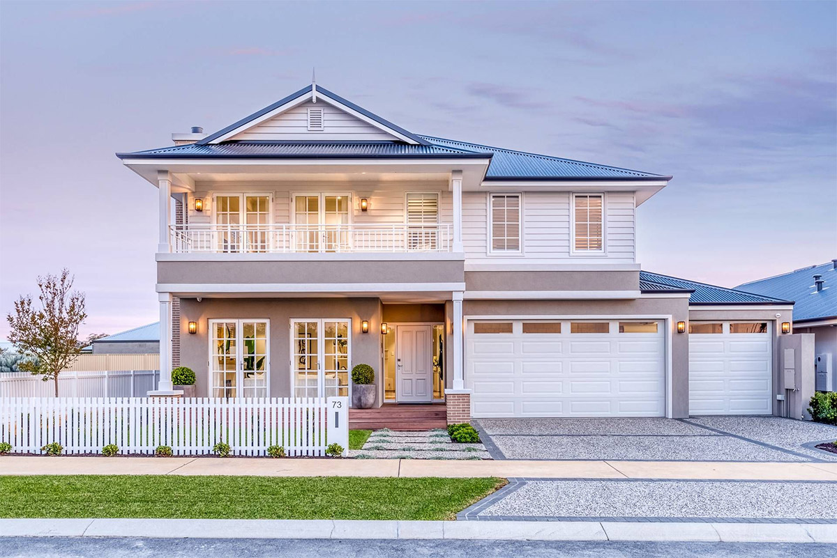 Two-story home with white picket fence and well-manicured lawn. A Grade Garage Doors, Perth