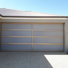 Modern garage door with frosted glass panels and light wood frame, providing privacy and style. A Grade Garage Doors, Perth