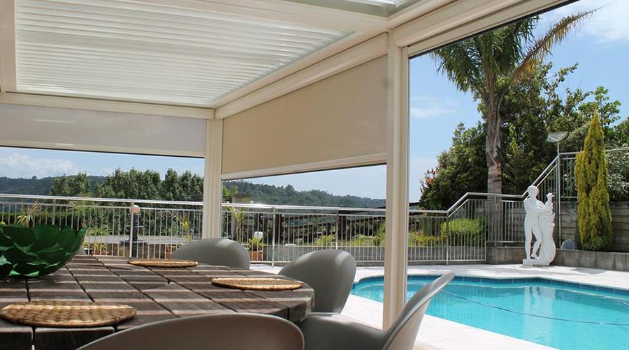 Outdoor patio with manual blinds, pool, and table setting. A Grade Garage Doors, Perth