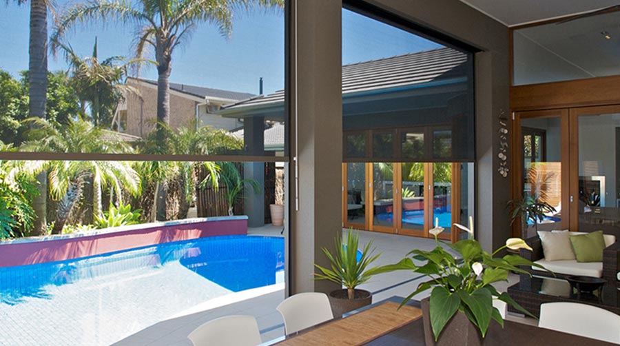 Outdoor patio with manual outdoor blinds, pool, and seating area. A Grade Garage Doors, Perth